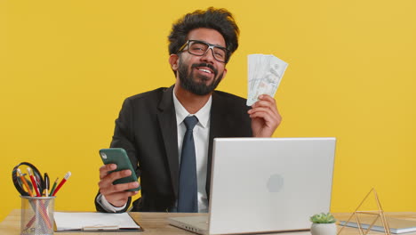 business man use smartphone rejoicing win receiving money dollar cash banknotes success lottery luck
