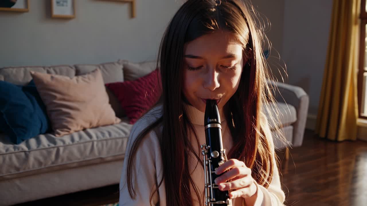 A serene video of a young girl playing the clarinet in a sunlit room, capturing a peaceful moment