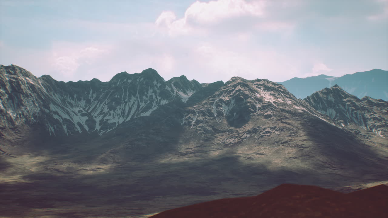 Majestic mountain range under bright sky during daytime exploration