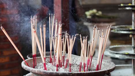 incense sticks burning in a pot