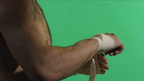 man wrapping his hands for boxing training