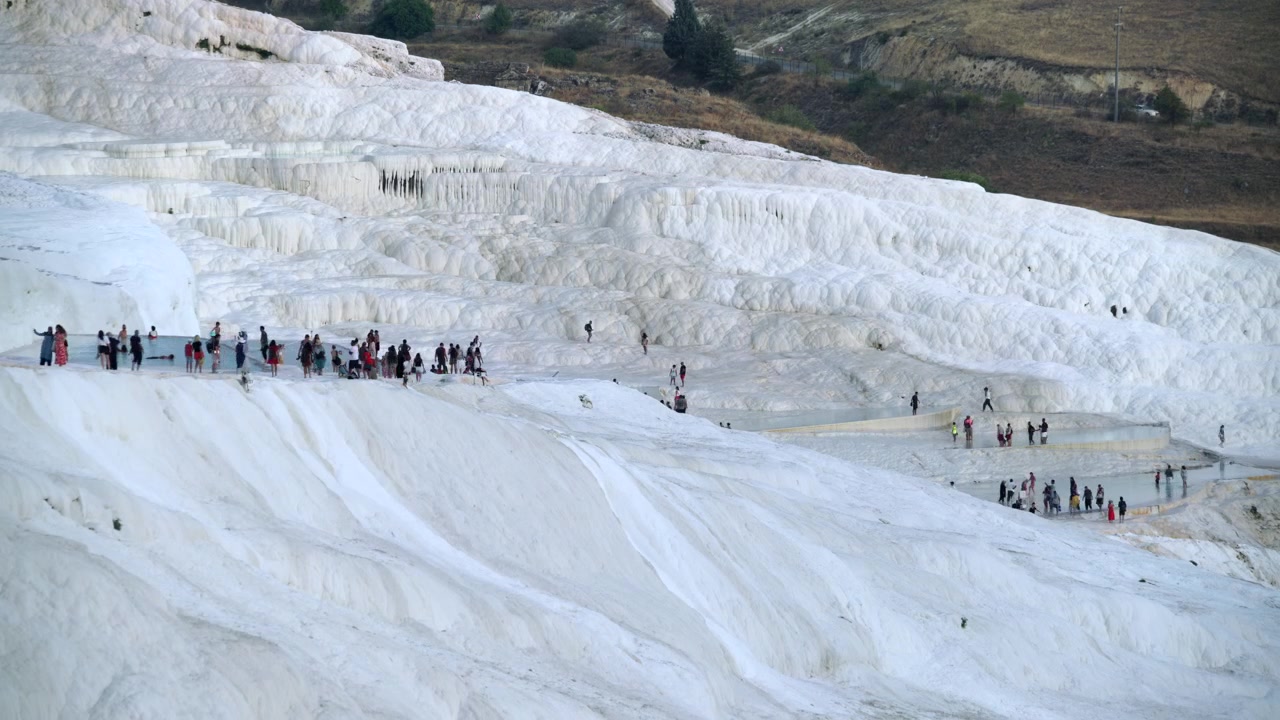 Tourists Walking on White Travertine Terraces of Pamukkale