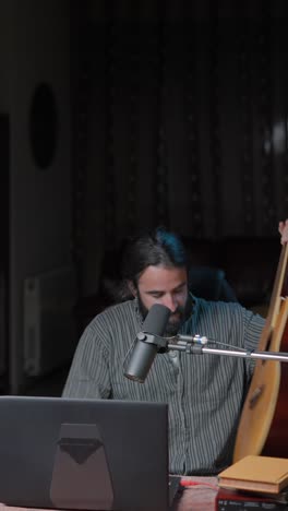 musician preparing for a recording session with an acoustic guitar