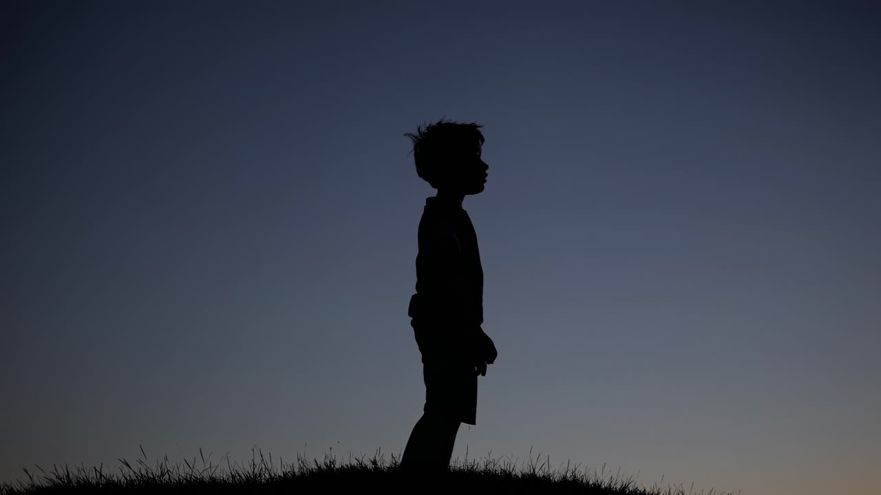 Silhouette of a Boy at Sunset