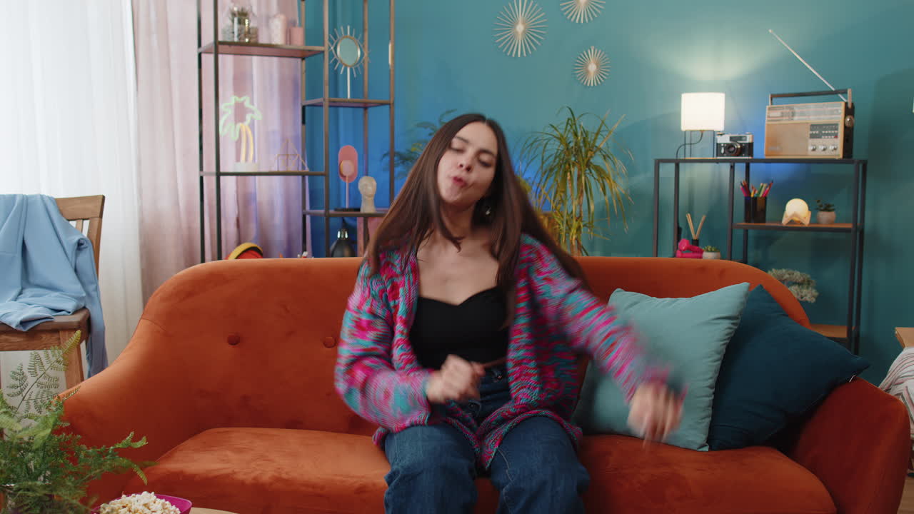 Woman girl having fun dancing and moving to rhythm dabbing raising hands making dub dance gesture