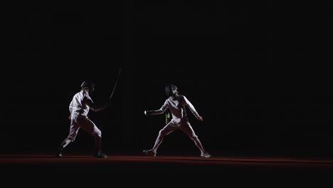 two fencers compete in a fencing match