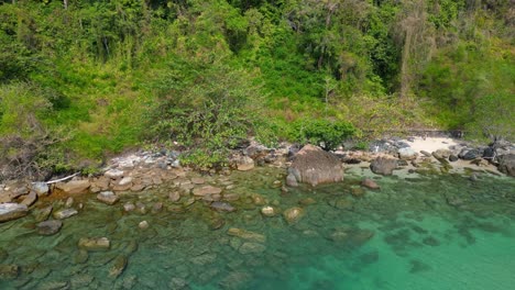 lush green hills and turquoise waters along koh chang's coastline. unique aerial view flight drone shot footage from above