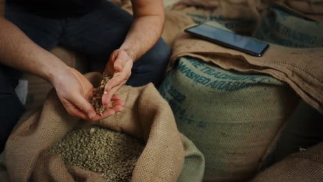 coffee farmer inspecting and recording coffee beans