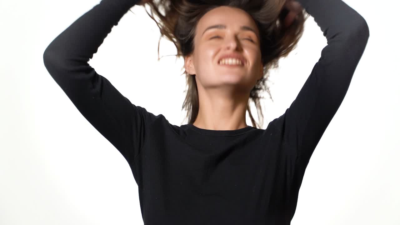 Isolated woman playing with hair. Close up portrait of happy woman playing with hair isolated on white background