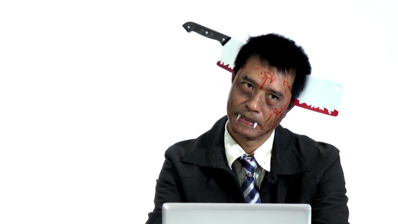 Crazy businessman using computer in halloween themes