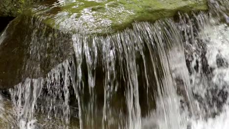 agua rápida que fluye sobre rocas en la montaña