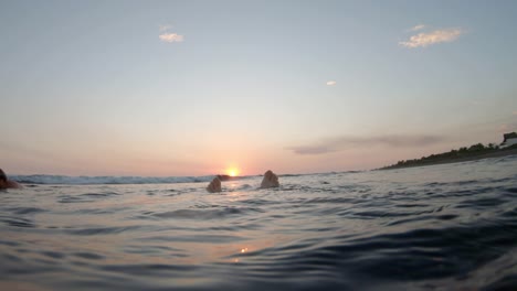 swimming floating pov underwater looking at sunset over ocean water