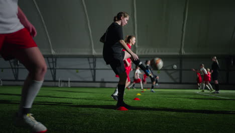 young women's soccer team training indoors