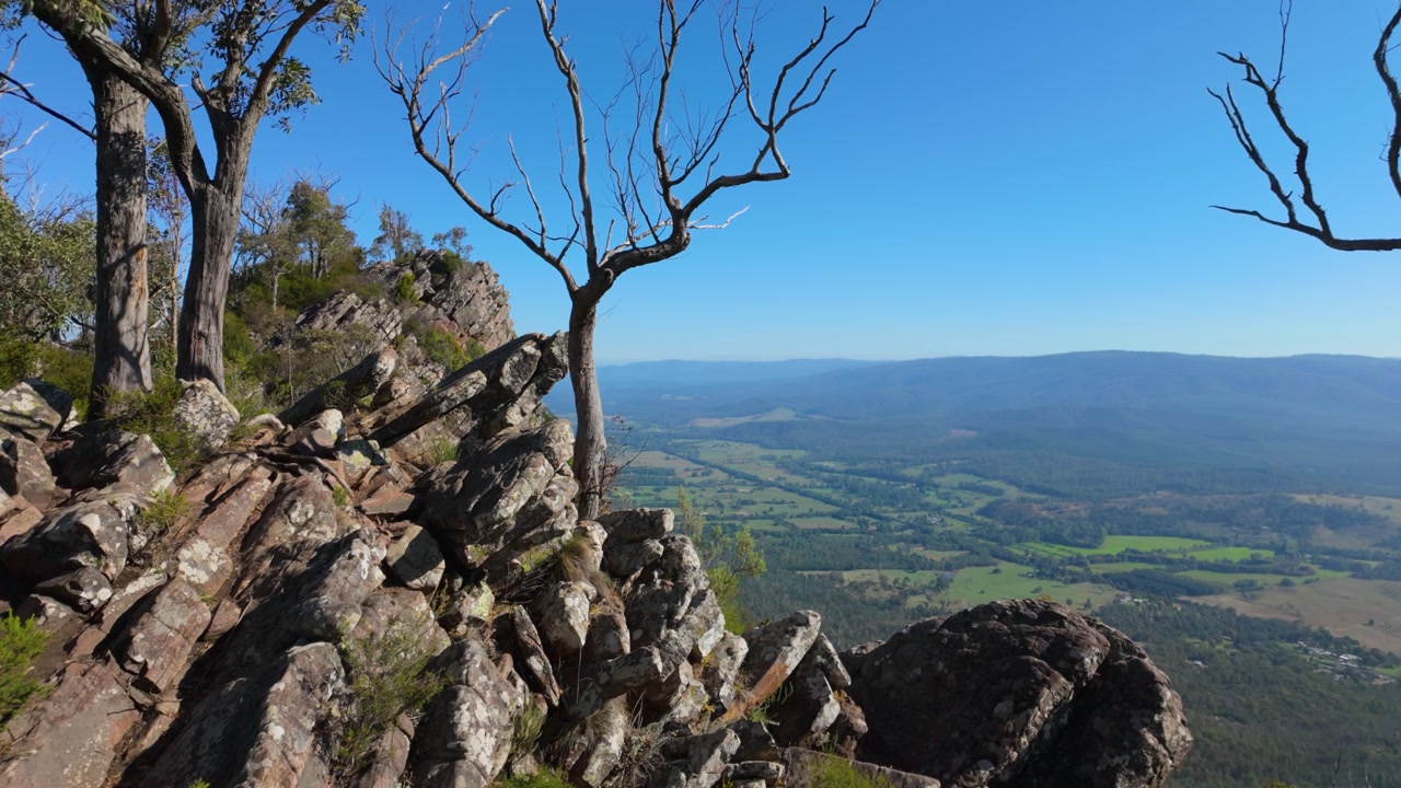 Sweeping views of the Razorback ridge line stretch across the horizon, with valleys below and dramatic skies creating a breathtaking mountain landscape.