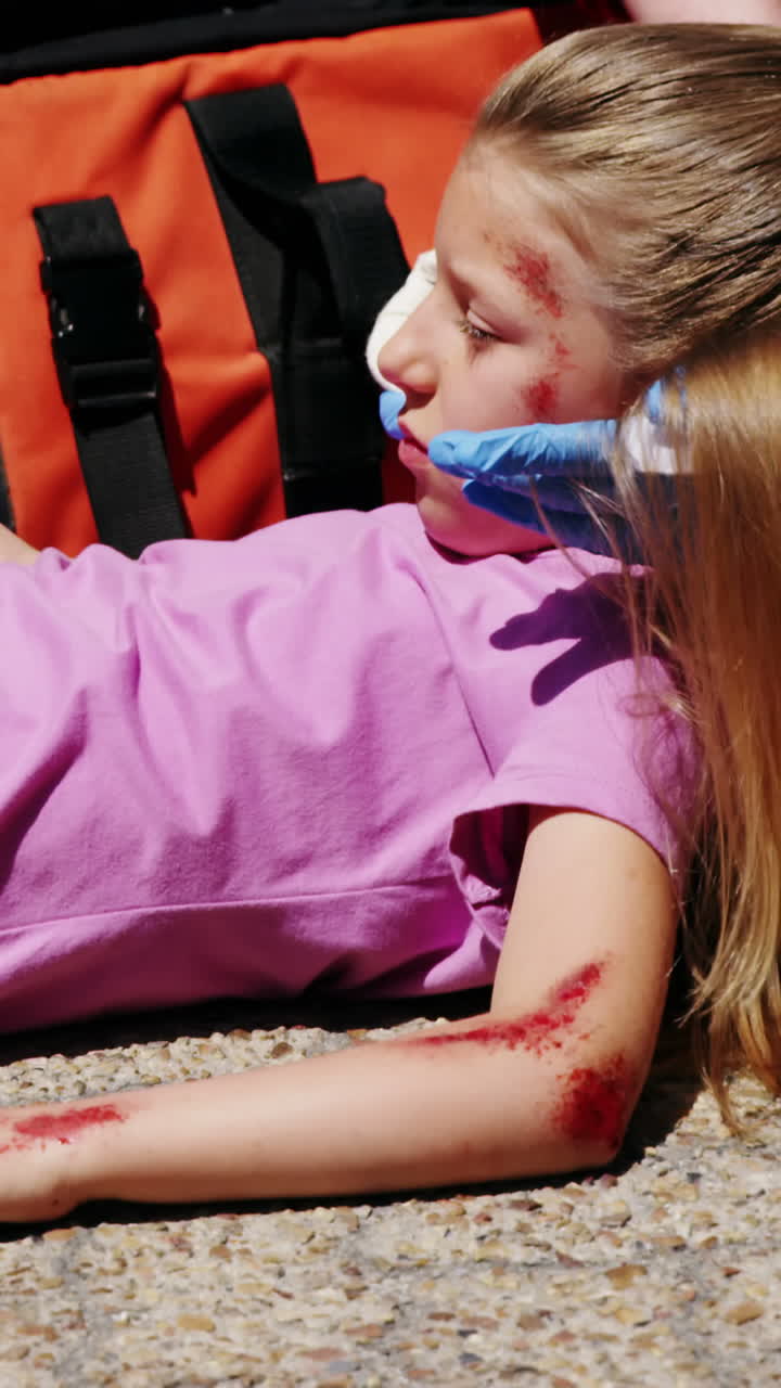 paramédicos examinando a una chica herida