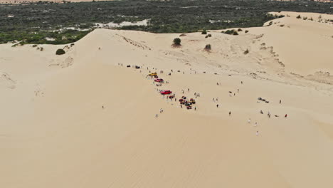 overhead drone shot of white sand dunes and bau trang lake in mui ne