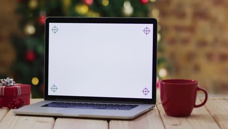 video of wooden table with laptop over christmas tree