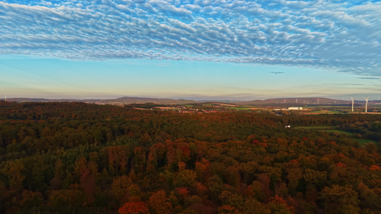Majestic autumn landscape at dusk with vibrant trees and a scenic horizon in this tranquil rural area in early evening light