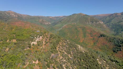 Seasonal-Autumn-fall-colors-of-mountain-forest,-aerial-view