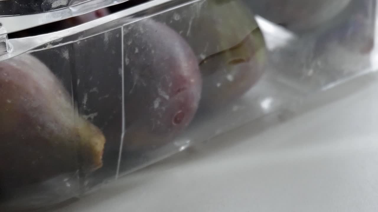 Fresh figs in clear plastic packaging showcasing natural freshness