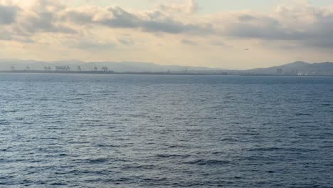 Sunset-in-the-port-of-Barcelona-skyline-plane-landing