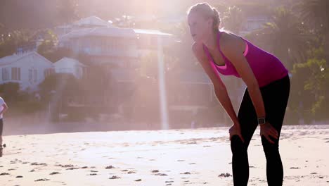 Woman-checking-time-on-beach