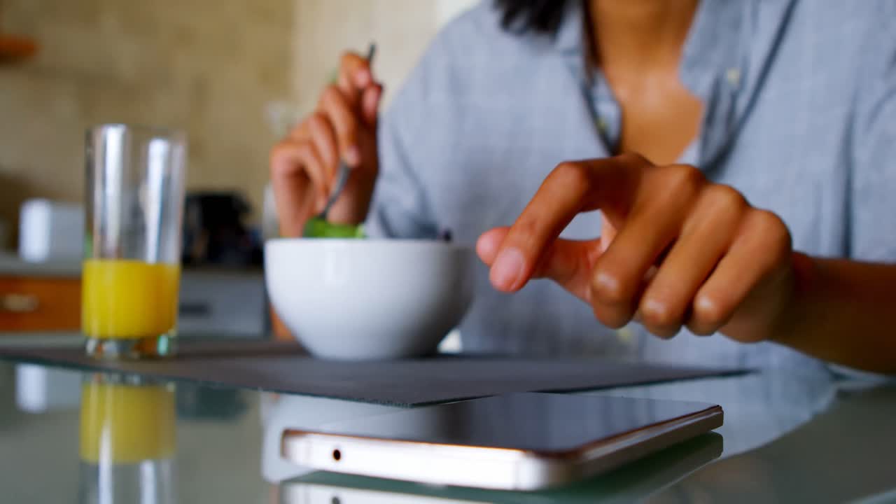Woman using mobile phone at home 4k