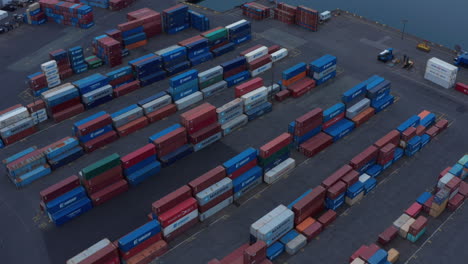 Rows-of-stacked-naval-containers-in-harbour.-Intermodal-transport-of-goods-on-long-haulage.-Logistics,-import-and-export-concept.