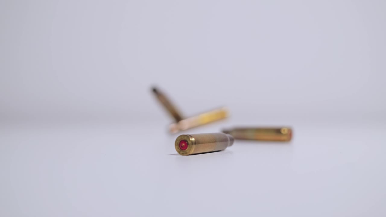 Symbolic close up of falling bullet casing in slow motion, deterrence concept