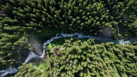 cascate del rutor waterfall surrounded by lush green forest, aerial view