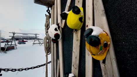 hard hats and safety helmets hanging on the side of a wall in the mining town of svalbard.