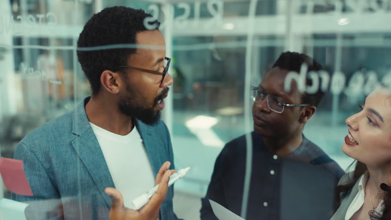Business people, planning and writing on glass