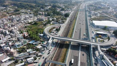 Traffic-on-a-Massive-highway-interchange-with-multiple-levels-and-loop-shaped-road-in-Hong-Kong,-Aerial-view