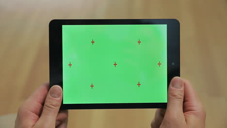 Male-hands-holding-tablet-with-green-screen.-Tablet-with-chroma-key-screen