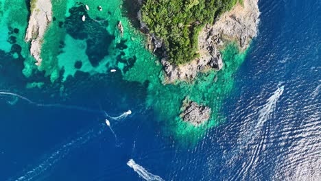 Boats-near-corfu-island-on-the-ionian-sea,-crystal-waters-around-limni-beach-glyko,-aerial-view