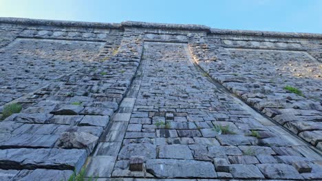 massive stone wall of kensico dam, valhalla, new york, usa. extreme low angle view