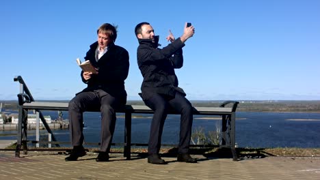 businessman taking a selfie with a smart phone outdoors