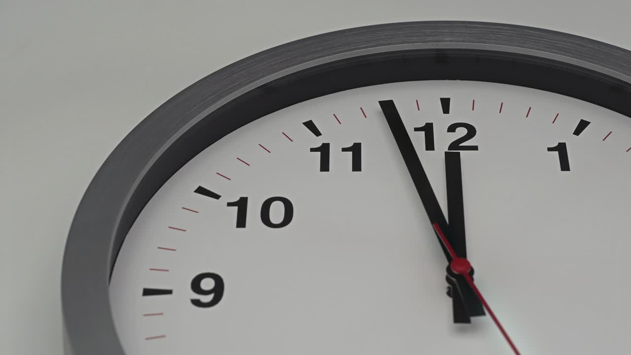 Truck shot close up of time-lapse gray clock with black arrows shows motion the time speed up from 11.00 a.m. to slow down 12.00 a.m., How time flies concept.