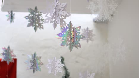 hanging snowflakes swaying in an indoor setting