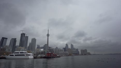 cn tower, skyline, boats and waterfront in cloudy toronto, wide static