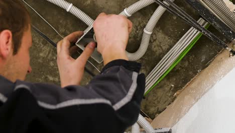 electrician installing ceiling wiring