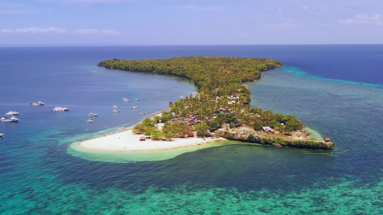 Establishing shot of Boracay island and beach, Philippines, pull back aerial