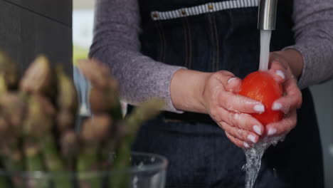 woman washes ingredients for salad 1