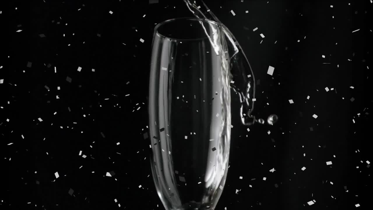 검은 배경에 떨어지는 콘페티와 함께 잔에  ⁇ 페인을  ⁇ 는 애니메이션