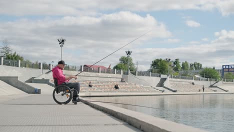 person with a physical disability who uses wheelchair fishing from fishing pier