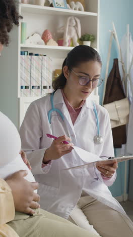 doctor consulting with a pregnant woman