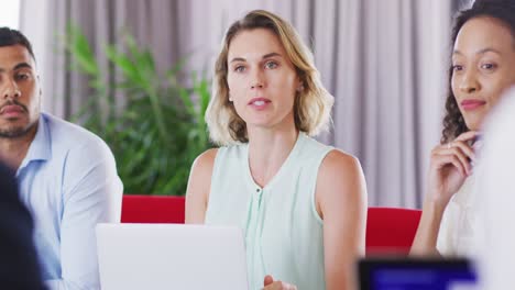 Professional-businesswoman-talking-to-her-colleagues-while-sitting-in-modern-office-in-slow-motion