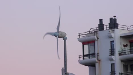 closeup of wind turbines generate electricity, windmill silhouettes at sunset