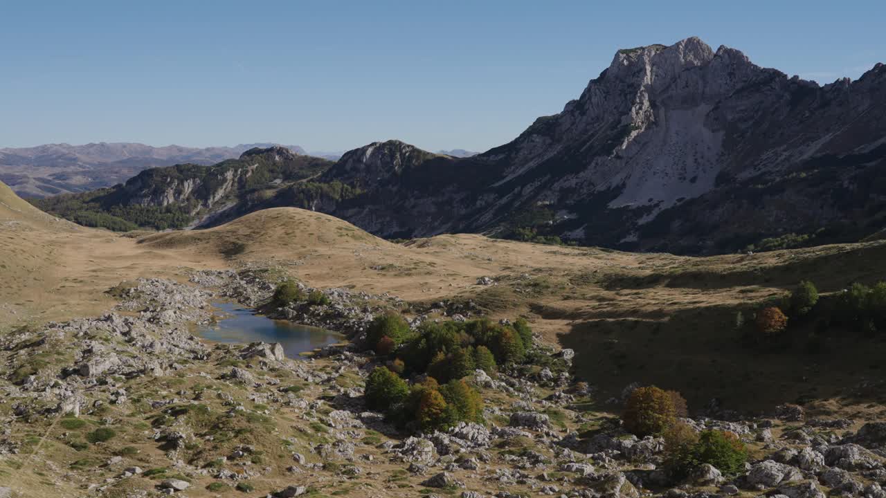 Alpine lake and rugged mountain peak in Durmitor National Park, Montenegro