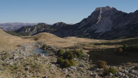 alpine lake and rugged mountain peak in durmitor national park, montenegro